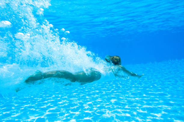 istock woman underwater in a swimming pool 913322796
