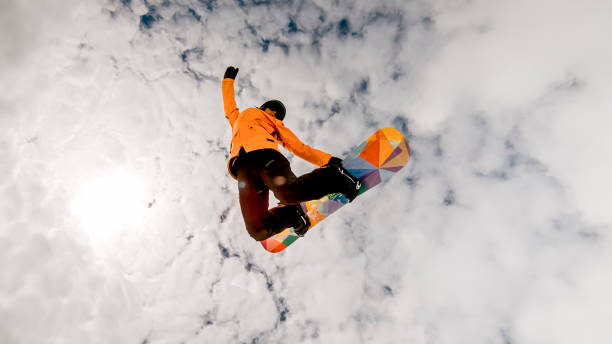 istock Woman jumping in air with snow board 913322818