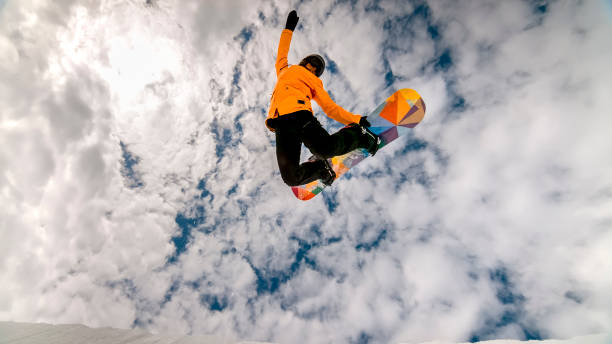Woman jumping in air with snow board
