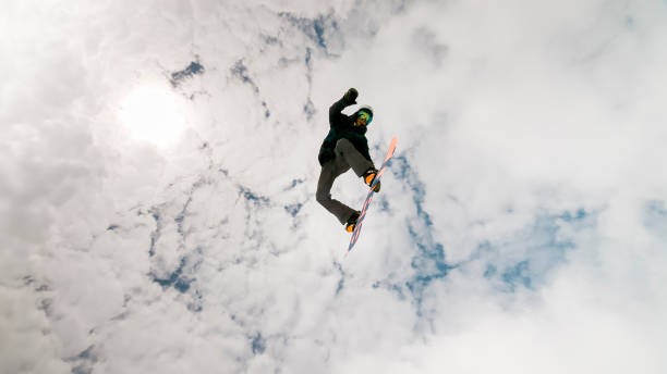 istock Man jumping in air with snow board 913322822