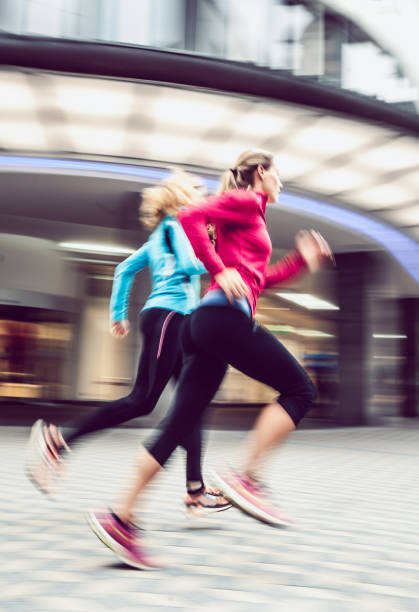 istock Two Female Athletes Running Outdoors, Blurred motion 913323608
