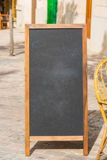Empty blackboard with place for text standing outside cafe or restaurant