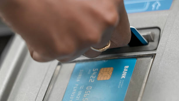 istock Female hand inserting bank card into ATM 913326848