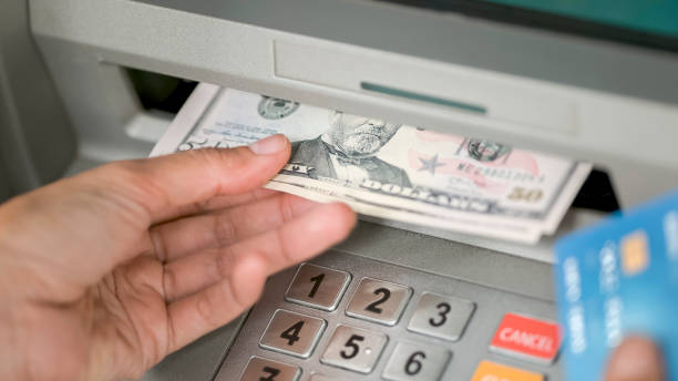 istock Person making cash withdrawal at ATM 913326864