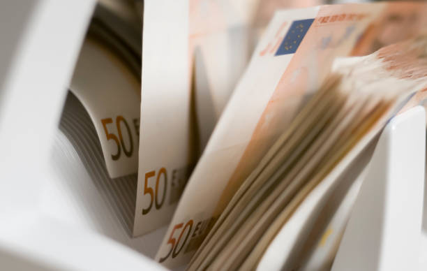 istock Currency counting machine counting fifty euro bank notes 913326924