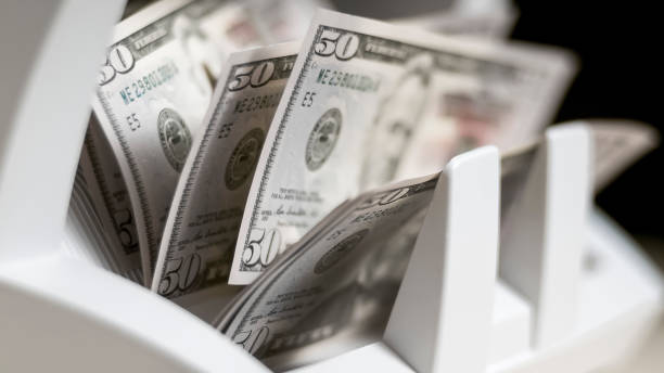 istock Currency counting machine counting fifty US dollar bills 913326932