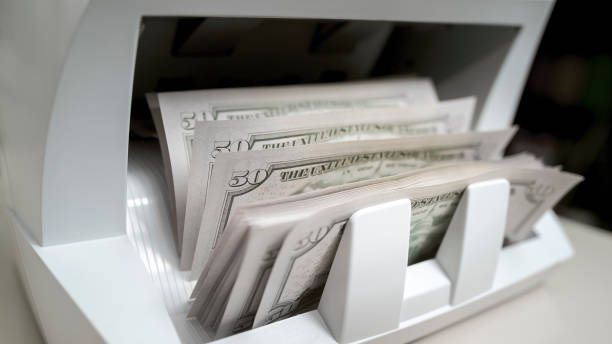 istock Currency counting machine counting fifty US dollar bills 913326944