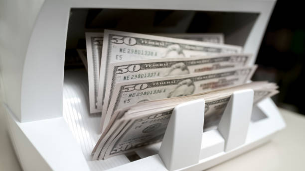 istock Currency counting machine counting fifty US dollar bills 913326950