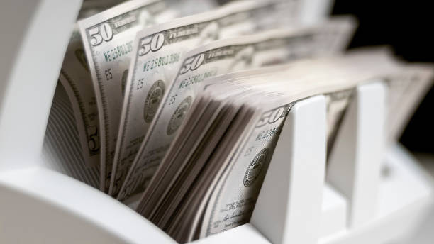 istock Currency counting machine counting fifty US dollar bills 913326952