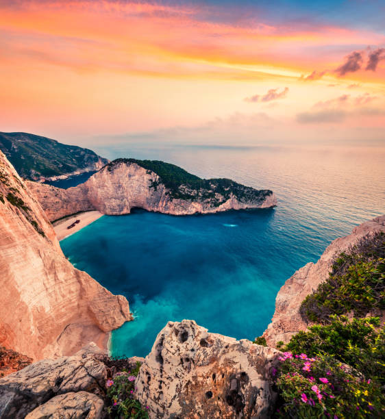 Fabulous spring scene on the Shipwreck Beach. Colorful sunset on the Ionian Sea, Zakinthos island, Greece, Europe. Beauty of nature concept background. Artistic style post processed photo. stock photo