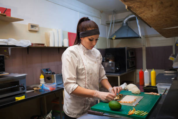 istock woman Cook prepares food sushi kitchen 913331102