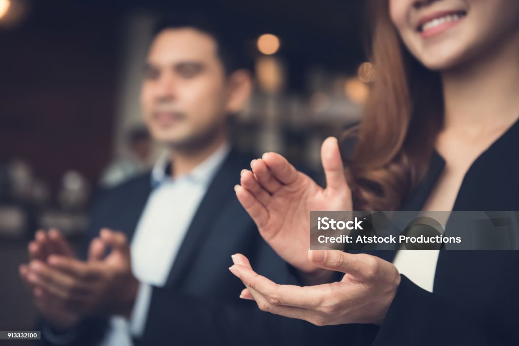 Business man and woman clapping hands at business meeting Businesswoman and businessman applauding an agreement during a business meeting in cafe Applauding Stock Photo