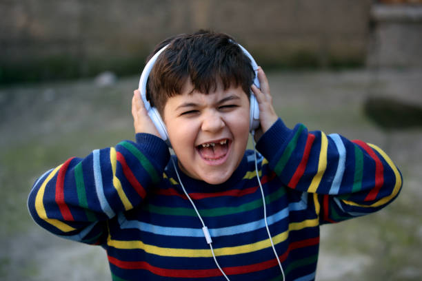 istock screaming little boy with headphones 913334374