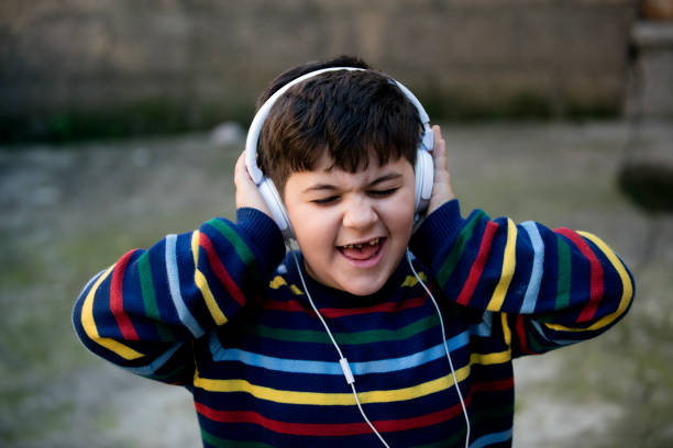istock screaming little boy with headphones 913334386