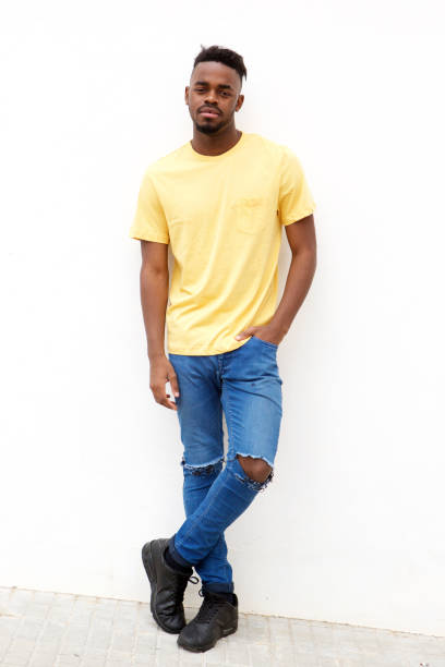 istock Full length cool young black man standing against white wall 913338262