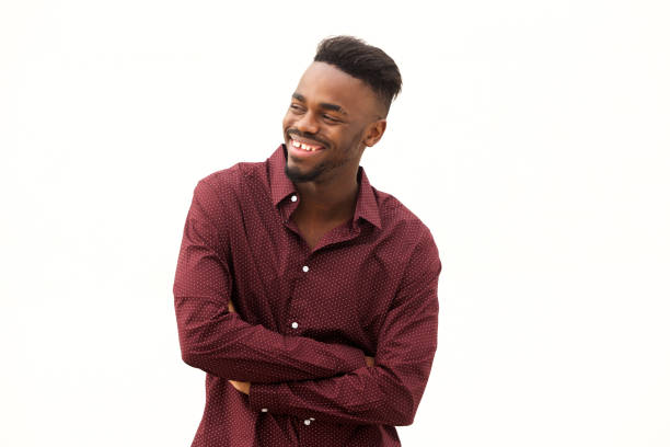 istock happy young  african man laughing by white background 913338372