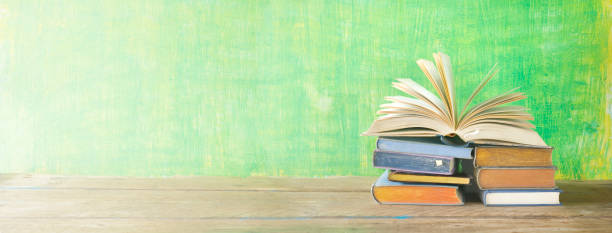 istock open book on a stack of books, reading, learning, literature concept 913338490