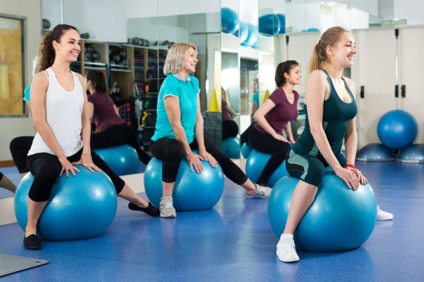 istock women jumping on exercise ball 913339646