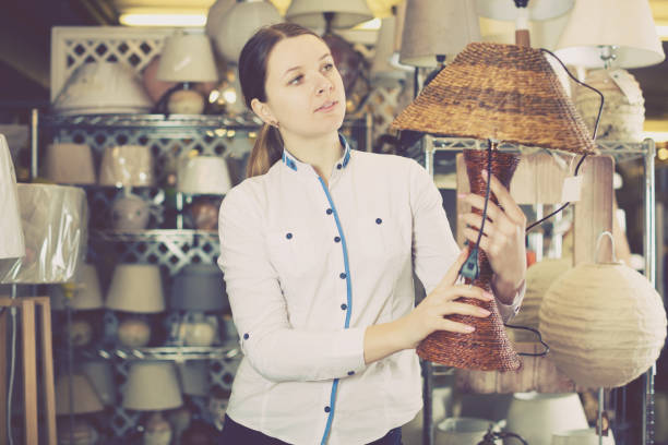 istock girl is standing with table lamp 913339692