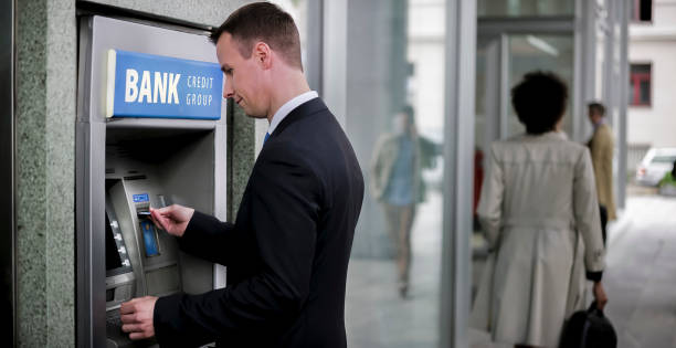 istock Businessman making withdrawal from ATM machine 913342768