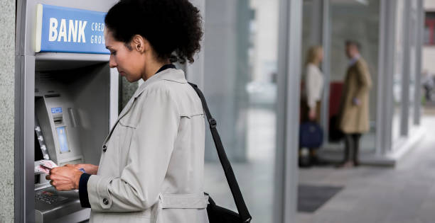istock Businesswoman making withdrawal from ATM machine 913342778