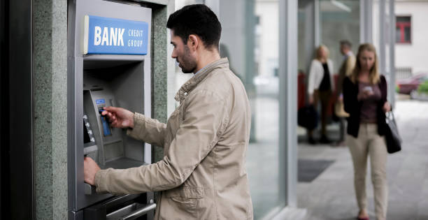 istock Businessman making withdrawal from ATM machine 913342792