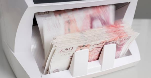 istock Money counter counting fifty pound banknotes 913342816