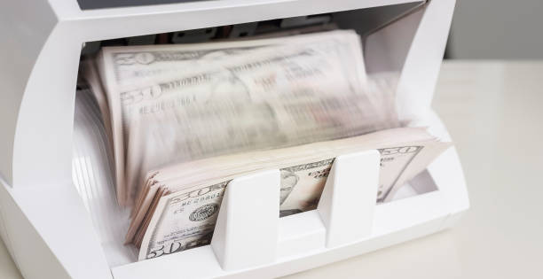 istock Money counter counting fifty US dollar banknotes 913342822