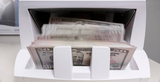 istock Money counter counting fifty pound banknotes 913342836
