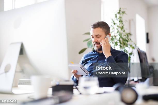 Businessman In Wheelchair At The Desk In His Office Stock Photo - Download Image Now