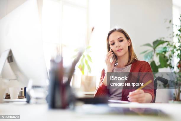 Businesswoman In Wheelchair At The Desk In Her Office Stock Photo - Download Image Now