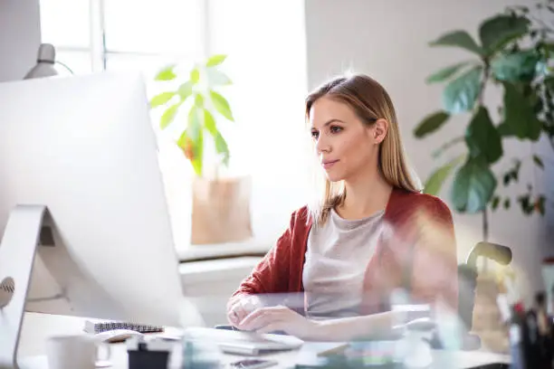 Photo of Businesswoman in wheelchair at the desk in her office.