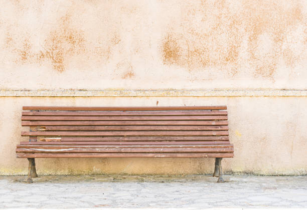 Old wooden bench in front of house facade background