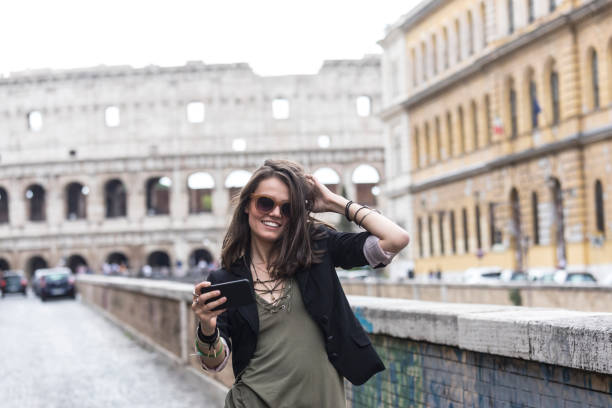 istock Smiling woman walking and talking on smart phone 913350742