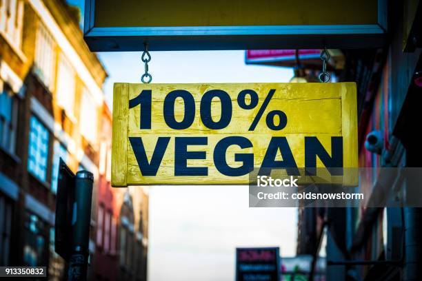 Close Up Of Restaurant Sign Outdoors On City Street Saying 100 Vegan Stock Photo - Download Image Now