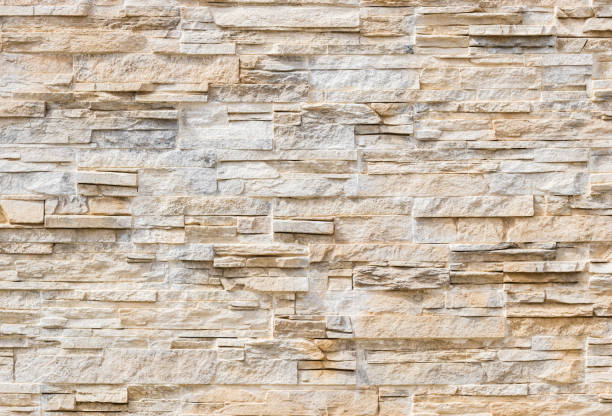 Modern stone wall Close-up of modern stone wall tiles background texture sand stone wall stock pictures, royalty-free photos & images