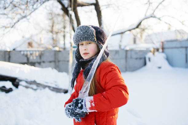 istock portrait of kid with big icicles during winter walk 913355160