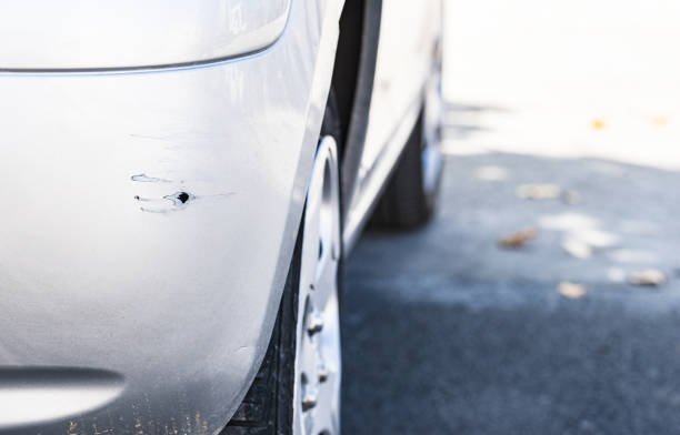 istock Car damage of scratched silver bumper 913359730