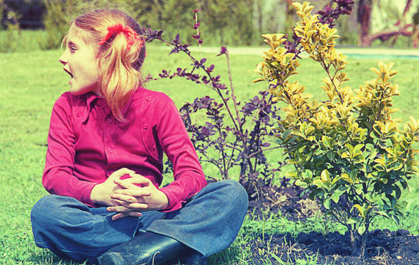 Vintage image from the seventies of a girl sitting outdoors and shouting out loud