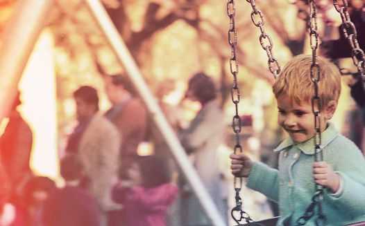 Vintage image of a kid in a playground hammock