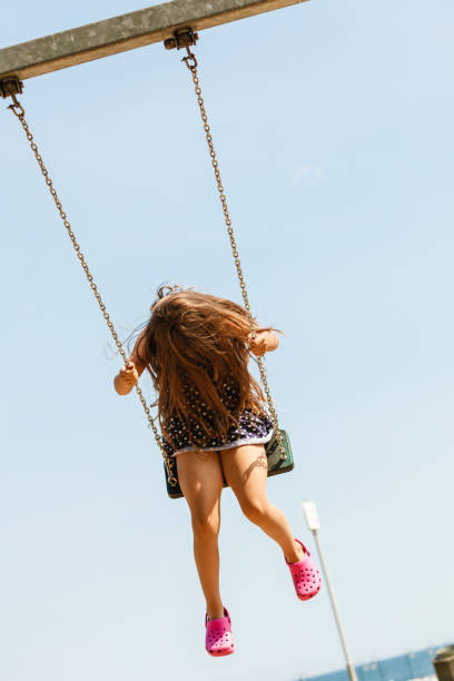 istock Girl swinging on swing-set. 913363962