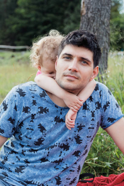 istock A girl wears a dad behind her neck. 913366736