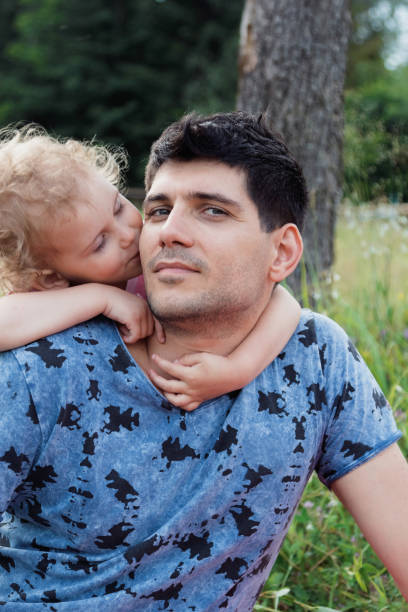 istock A girl wears a dad behind her neck. 913366742