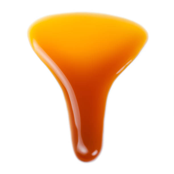 istock Caramel splashes isolated on white background. Spilled caramel sauce, toffee toppings 913370840