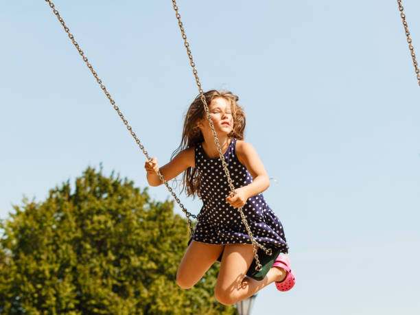 istock Girl swinging on swing-set. 913370982