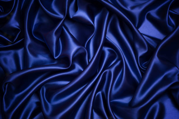 istock Dark blue satin background and texture, Grooved of blue fabric abstract 913372354