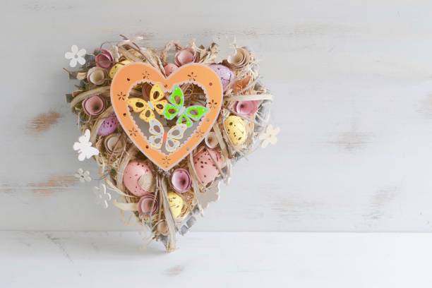 istock Heart shaped  Valentine easter wreath with eggs and flowers, heart shape on white 913375670