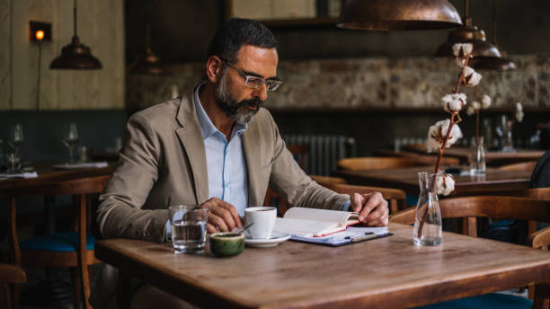 istock Senior businessman in an internet cafe working 913377688