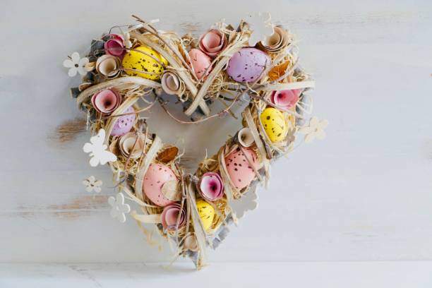 Heart shaped Valentine easter wreath with eggs and flowers, heart shape on white