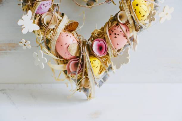 istock Valentine easter wreath with eggs and flowers, heart shape on white 913377982